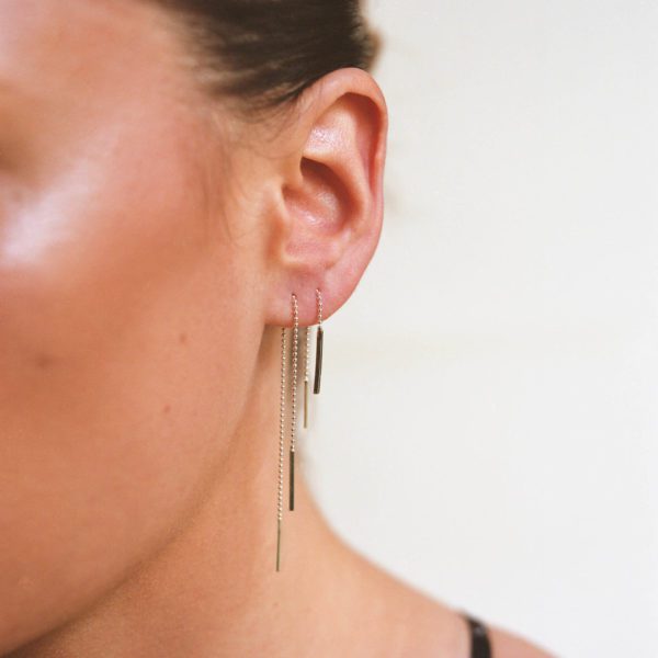 product image threader earrings in both piercings